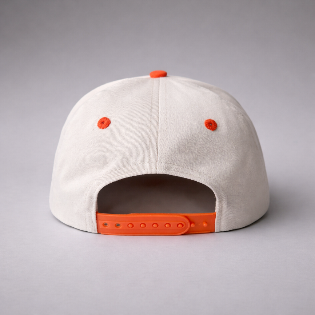 Beige cap with orange accents on a gray background