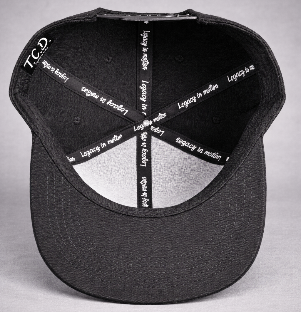 Black cap with white text on a gray background