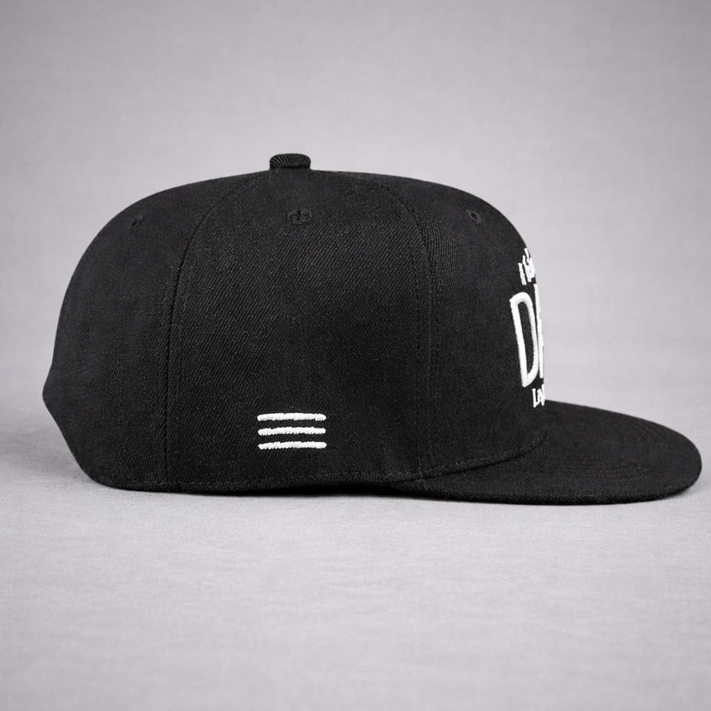 Black cap with white text and logo on a gray background